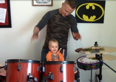 Small child playing on a drumset